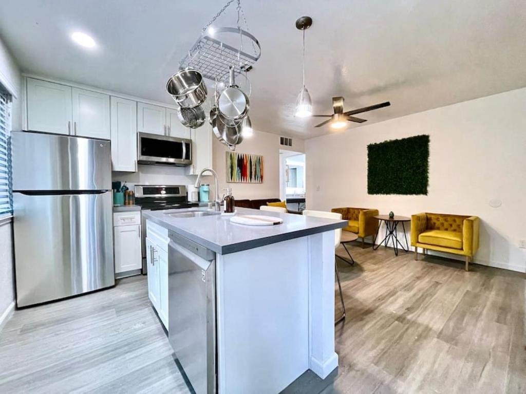 a kitchen with white cabinets and a large kitchen island at Quiet Remodeled 3 Bedroom in Heart of Downtown Sacramento in Sacramento