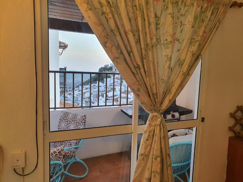a room with a window with a view of a balcony at Finca Eva 34 Casares Historico in Casares