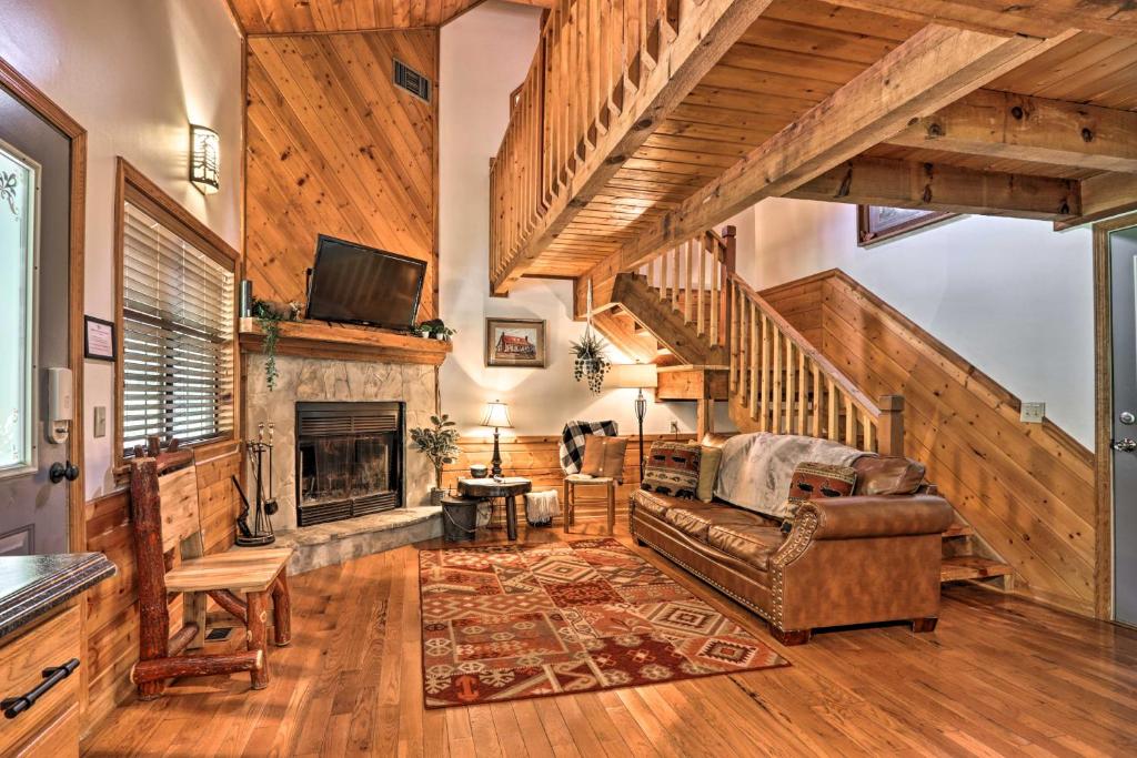 a living room with a couch and a fireplace at CREEKSIDE Tiny Cabin by Pigeon Forge in Sevierville