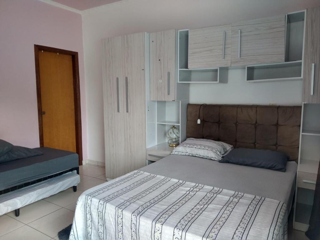 a bedroom with two beds in a room at Casa de temporada in São João Batista do Glória