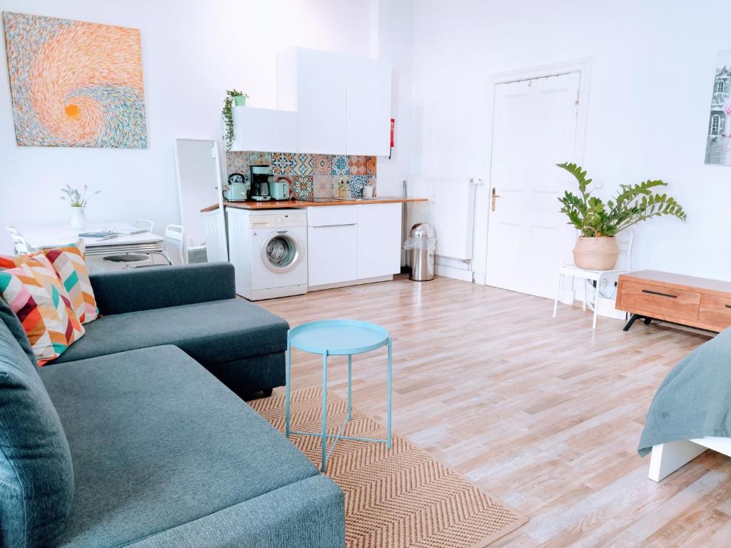 a living room with a couch and a table at Cozy studio in Friedrichshain, 4 quiet guests only in Berlin
