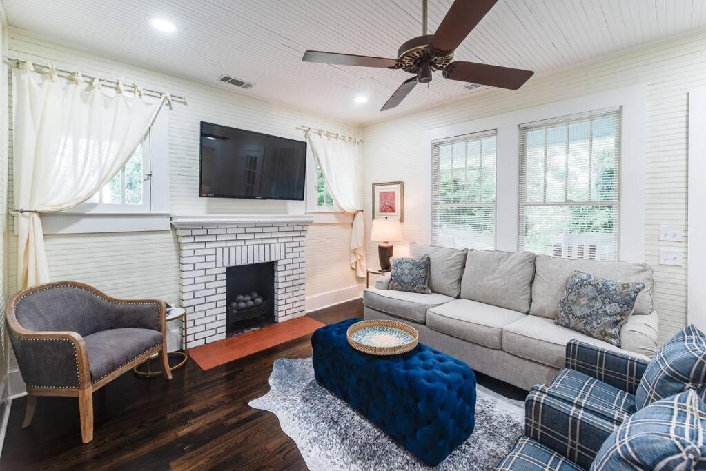 a living room with a couch and a fireplace at Adorable home near the University of Alabama in Tuscaloosa