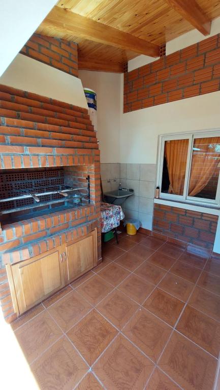 a kitchen with a brick wall and a brick floor at Su y Nacho in Puerto Rico