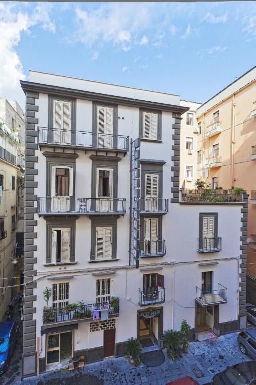 an apartment building with balconies in a city at Albergo del Golfo in Naples