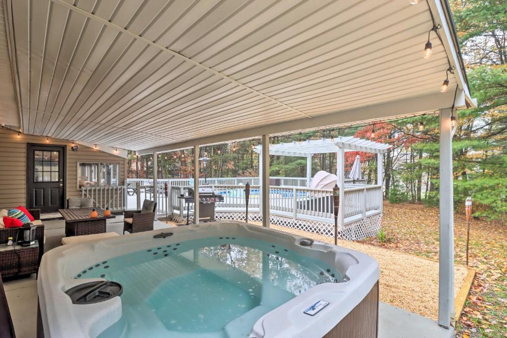 a large hot tub in a patio with a roof at Pocono Home with Hot Tub, Fireplace and Game Room! in Saylorsburg