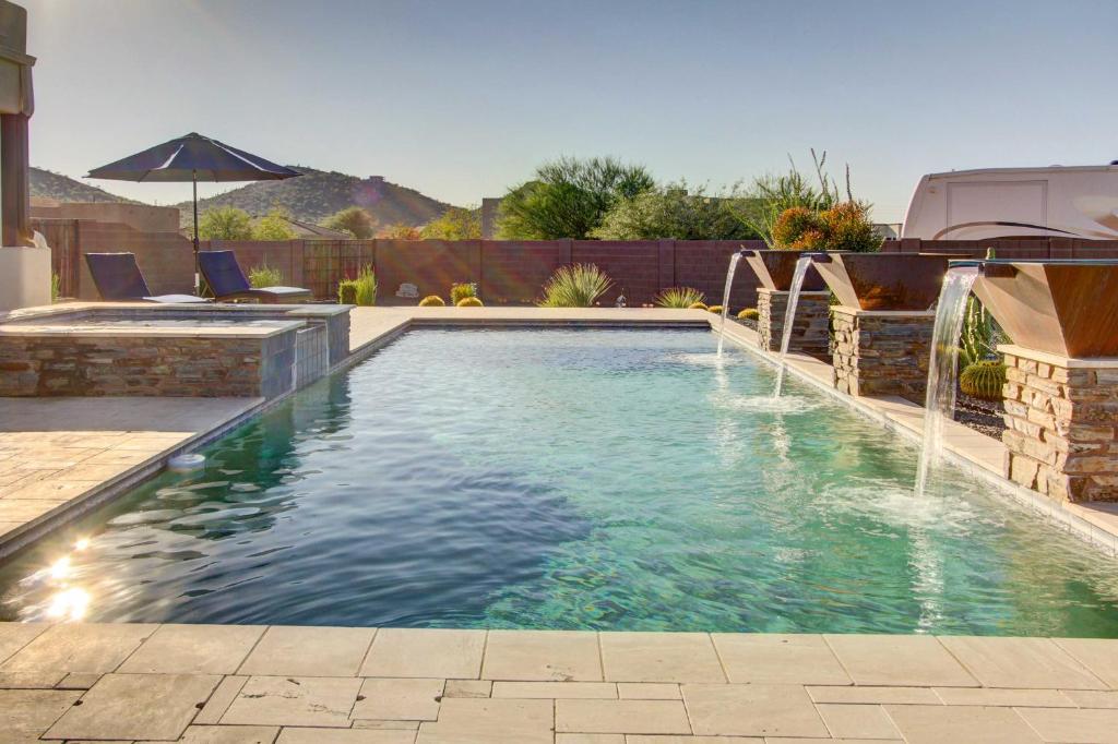 a swimming pool with a water fountain in a yard at Private Pool! Oasis-Like Group Getaway in Phoenix in Anthem