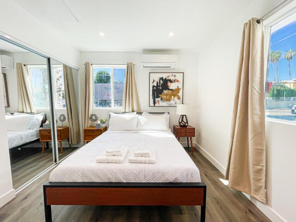 a bedroom with a bed with two towels on it at Cozy Habitat in Los Angeles