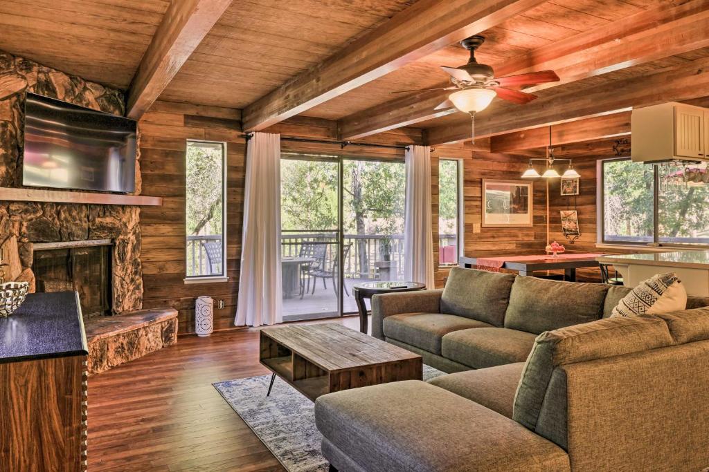 a living room with a couch and a fireplace at Spacious Groveland Cabin with Wraparound Deck! in Groveland