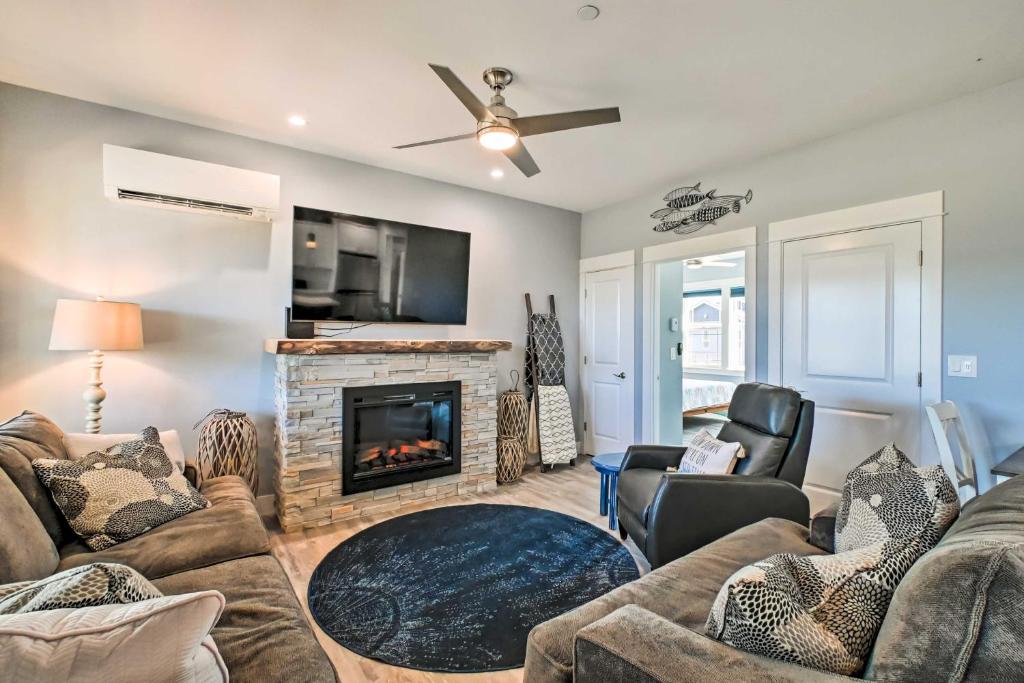 a living room with a couch and a fireplace at Ocean Shores Getaway with Fireplace and Hot Tub! in Ocean Shores