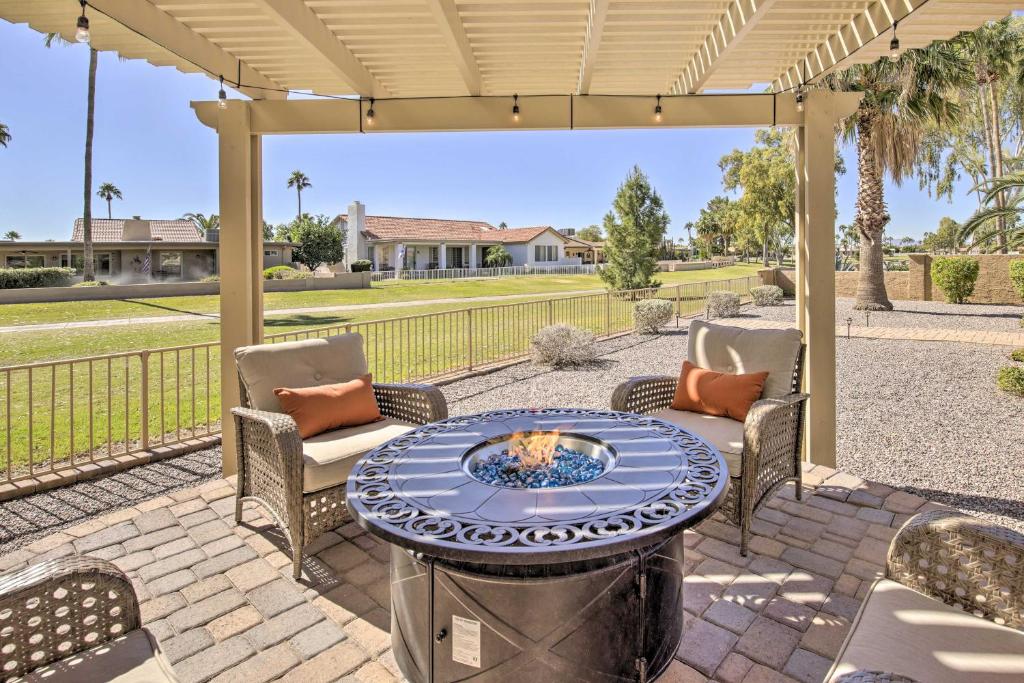 a patio with a table and chairs under a pergola at Stunning Sun Lakes Retreat Less Than 1 Mi to Golfing! in Sun Lakes