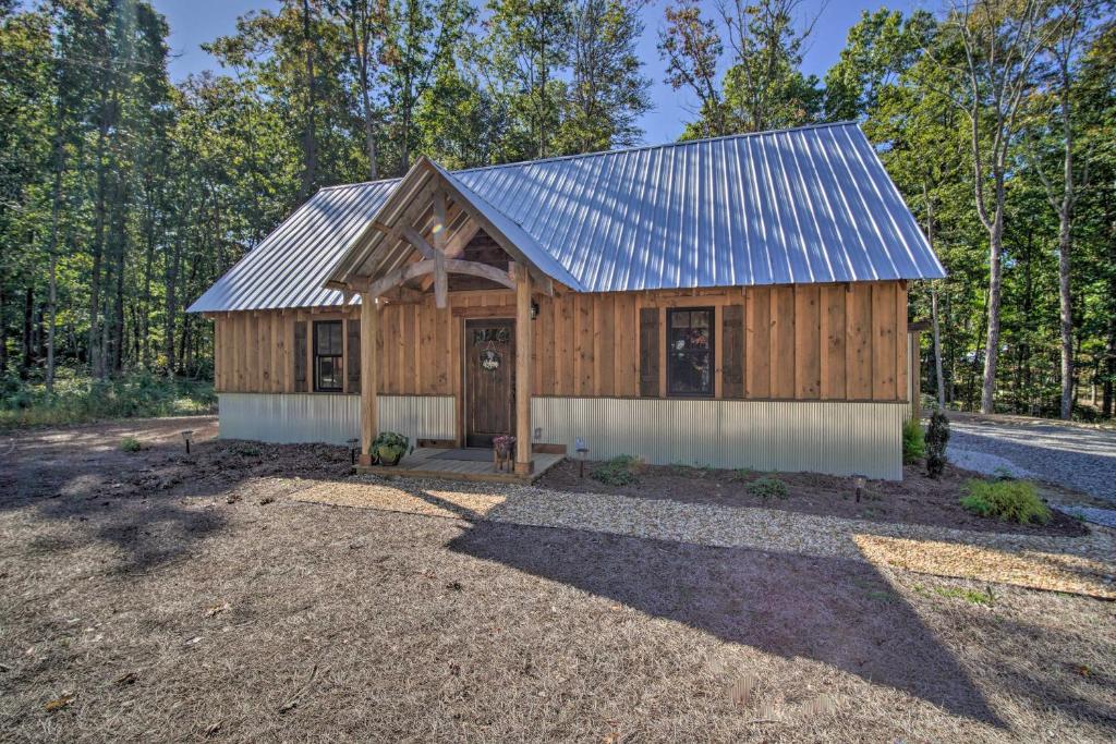 a barn style house with a metal roof at Stunning Cabin Getaway with Private Hot Tub! in Rising Fawn