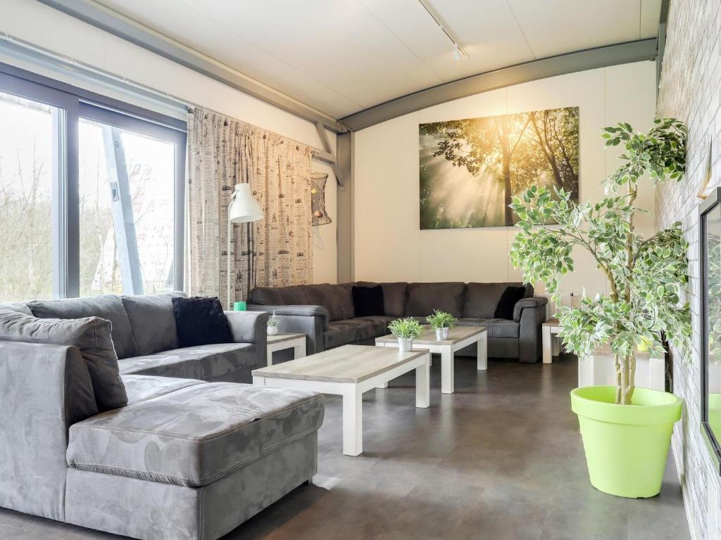 a living room with a couch and a table at Attractive holiday home in Noordwolde with sauna in Noordwolde