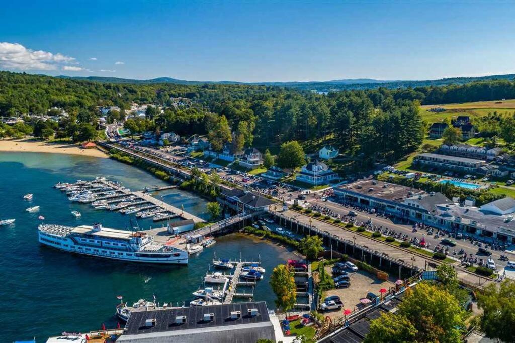 an aerial view of a marina with boats in the water at Spacious Condo Walking distance to Weirs in Laconia