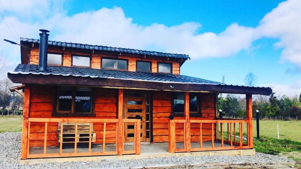a log cabin with a roof on top of it at Cabaña By Casur panguipulli in Panguipulli