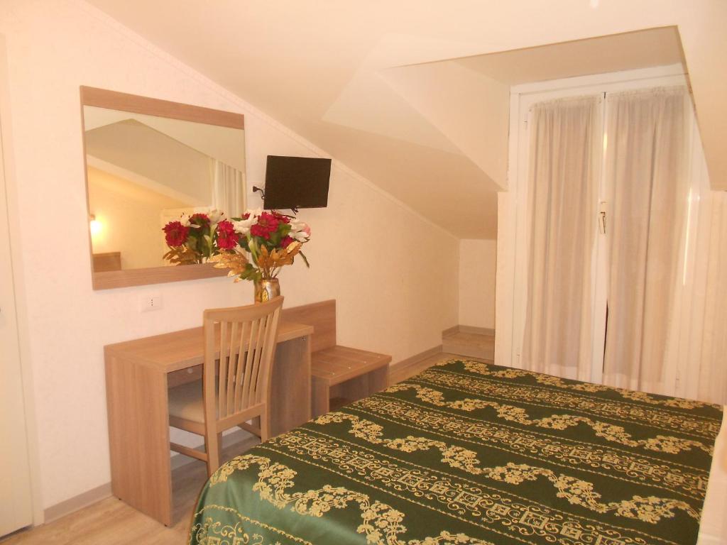 Postel nebo postele na pokoji v ubytování Hotel Concorde