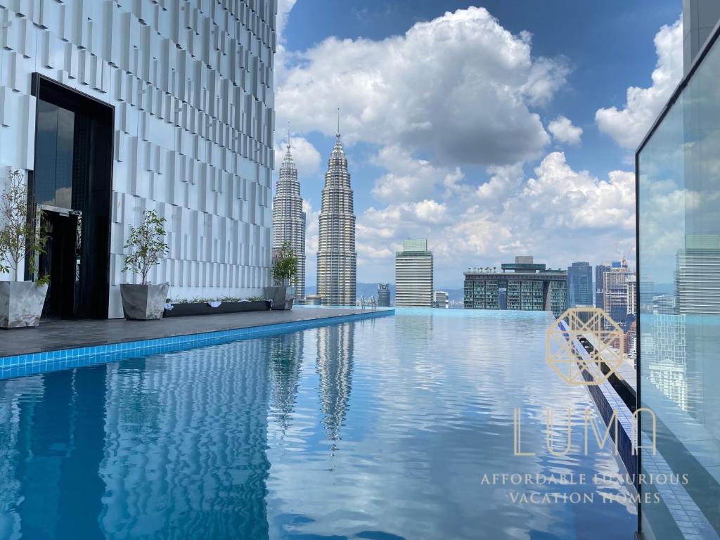 a swimming pool on the roof of a building with tall buildings at The Platinum 2 Kuala Lumpur by LUMA in Kuala Lumpur