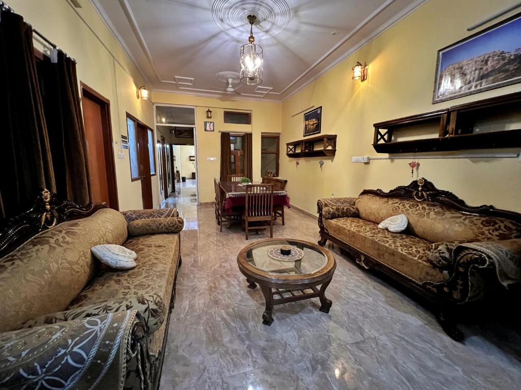 a living room with couches and a coffee table at Beena Homestay in Jaipur