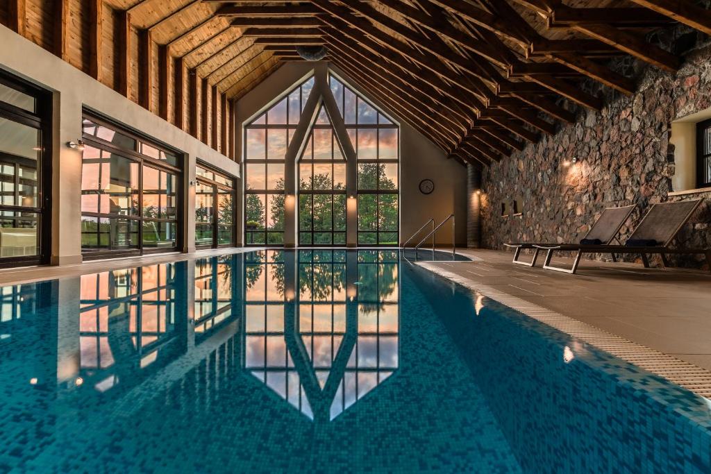 an indoor pool in a building with glass windows at Siedlisko Morena in Stare Juchy