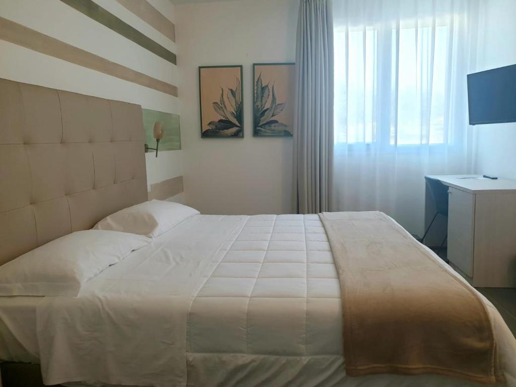Postel nebo postele na pokoji v ubytování Hotel Grel