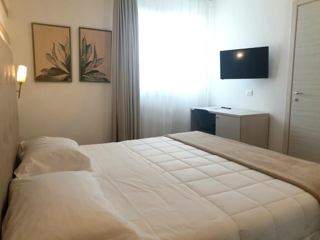 Postel nebo postele na pokoji v ubytování Hotel Grel