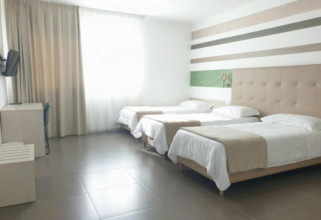 Postel nebo postele na pokoji v ubytování Hotel Grel