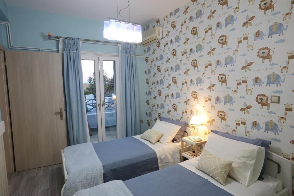 Postel nebo postele na pokoji v ubytování Vacation house with stunning view - Vari Syros