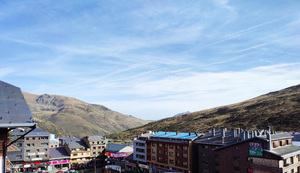 a city with buildings and mountains in the background at Duplex Holidays Andorra in Pas de la Casa