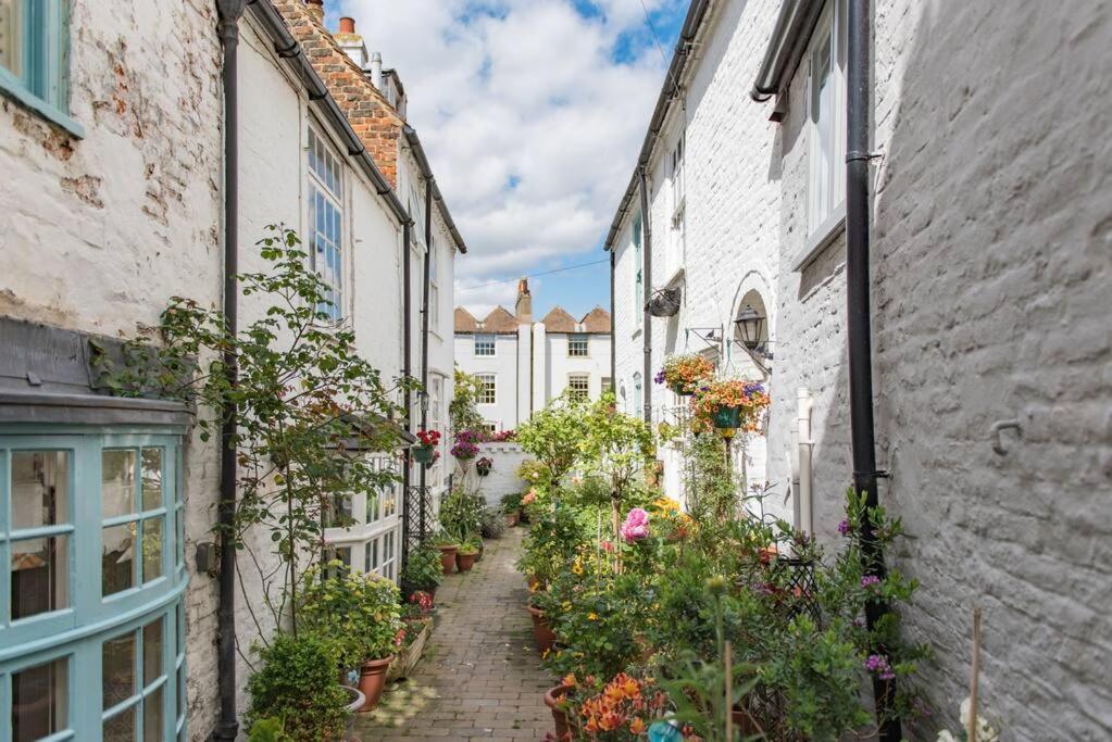 an alley in an old town with flowers at Portobello Court in Kent