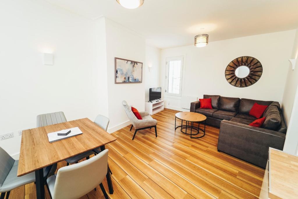 a living room with a couch and a table at Cottages in Derbyshire - Duffield Apartment in Duffield