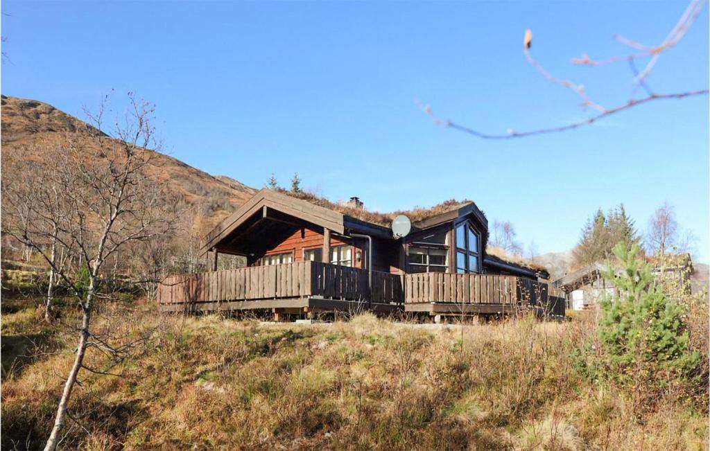 a house sitting on top of a hill at Awesome Home In Straumgjerde With Sauna, 4 Bedrooms And Wifi in Brunstad