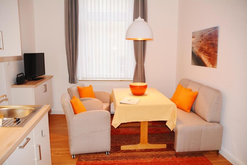 a small living room with a table and two chairs at Ferienhaus Pauls Ferienhaus Pauls, Whg 03 in Norderney