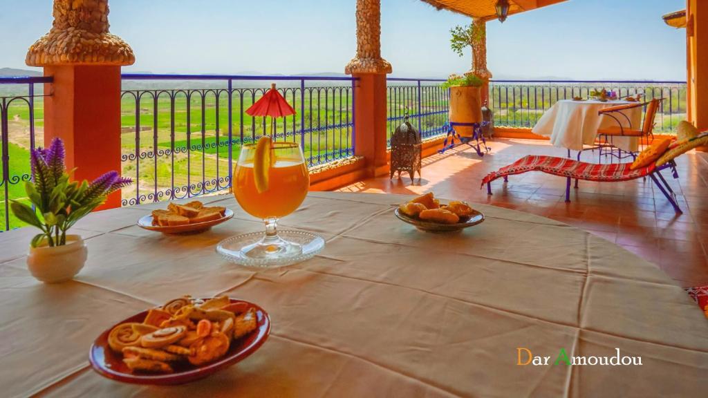 a table with a drink and some food on it at Dar Amoudou in Ouarzazate