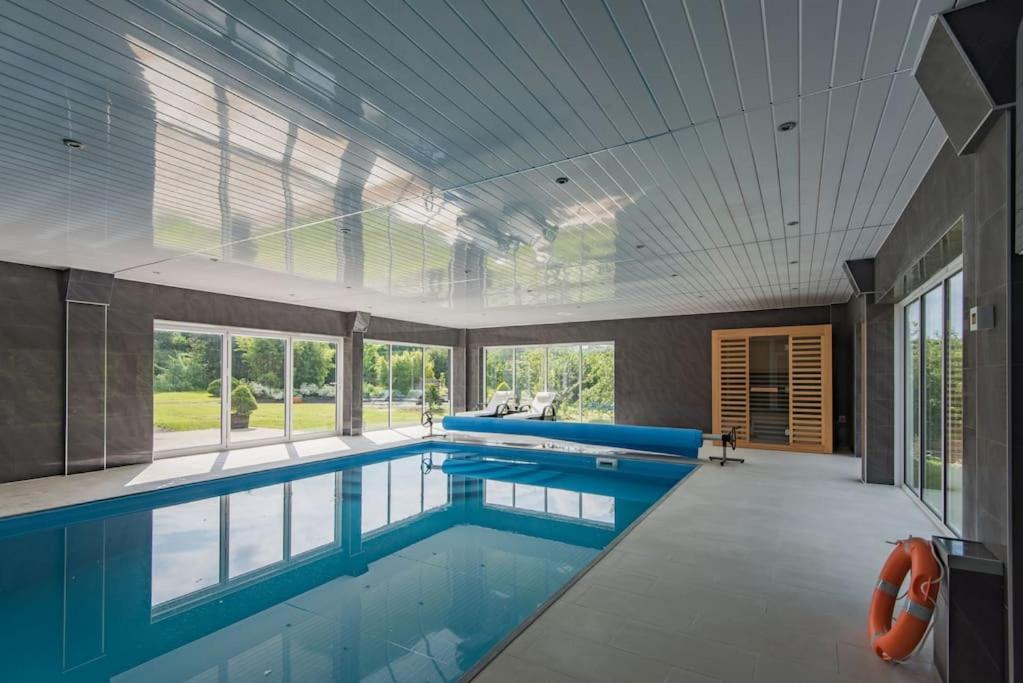 a swimming pool with blue water in a building at Reed Loft in Kingston