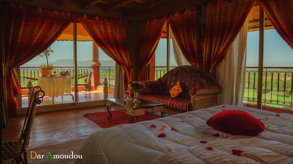 a bedroom with a bed and a balcony at Dar Amoudou in Ouarzazate