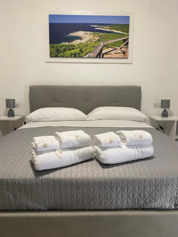 ein Schlafzimmer mit einem Bett mit drei Handtüchern darauf in der Unterkunft LecceMareSalento in Lecce