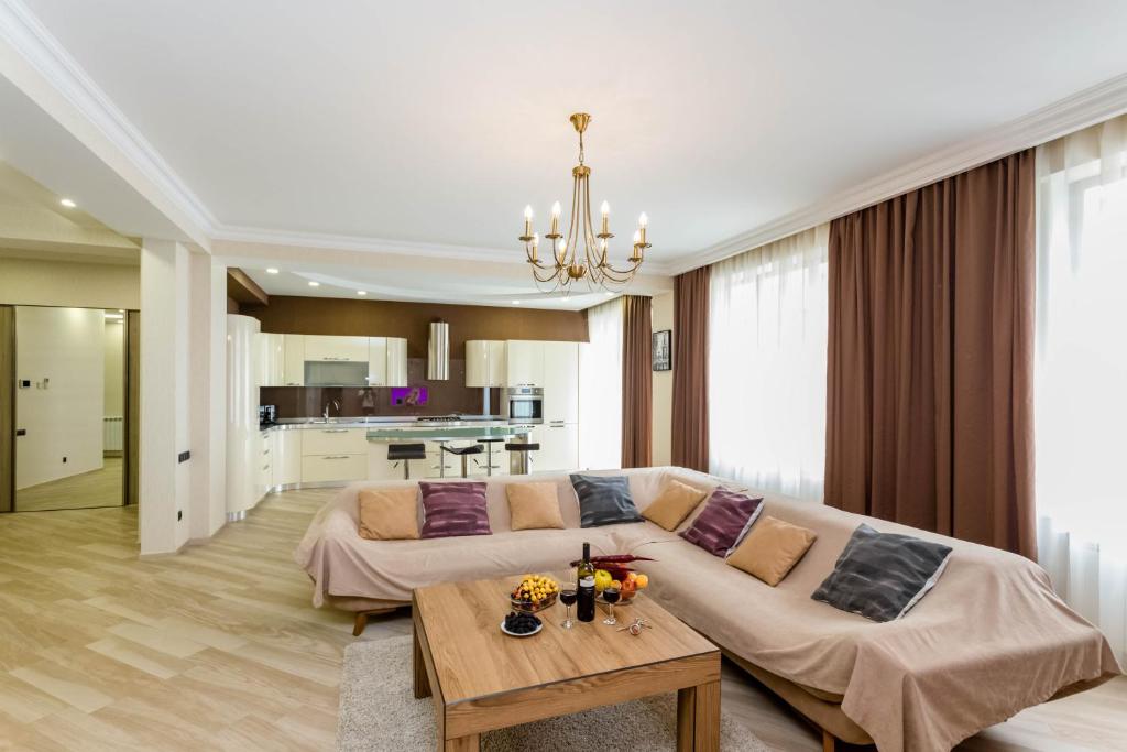 a living room with a couch and a table at Luxury Landing ll in Tbilisi City