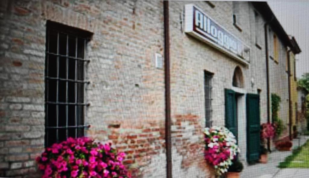 a brick building with flowers on the side of it at ALLOGGIO LA LUNA 