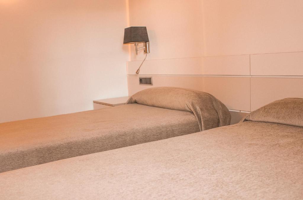 Postel nebo postele na pokoji v ubytování Hotel Saloria