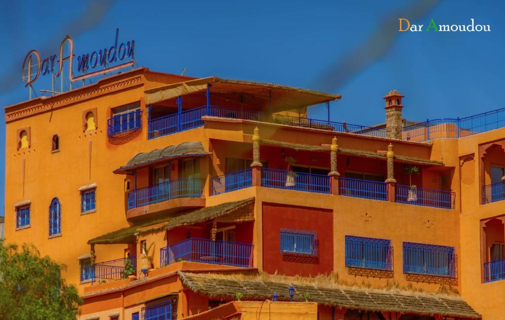 a yellow building with a sign on top of it at Dar Amoudou in Ouarzazate