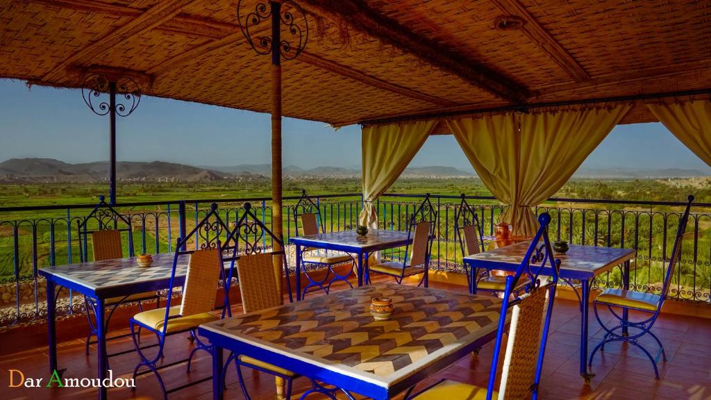 a room with two tables and a chess board on a balcony at Dar Amoudou in Ouarzazate