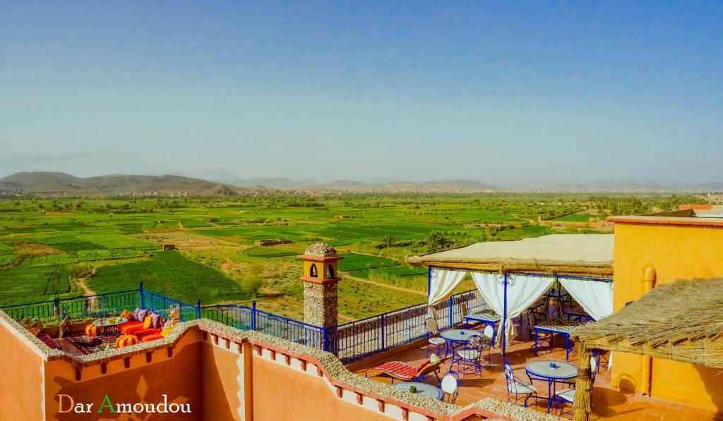 a balcony of a building with a view of a field at Dar Amoudou in Ouarzazate
