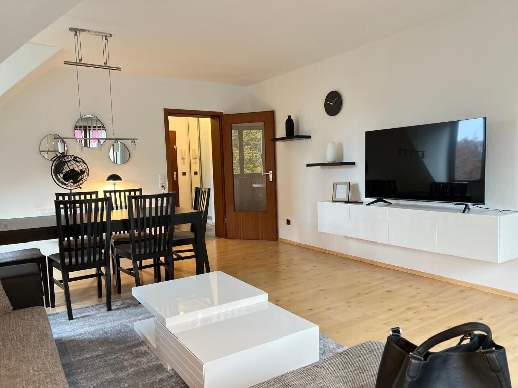 a living room with a large tv and a table at Apartment an der Altstadt in Hameln