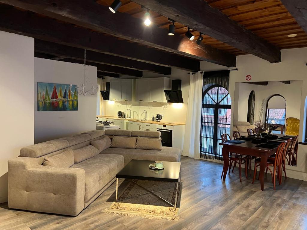 a living room with a couch and a table at Tiltų 5 Apartment in Klaipėda