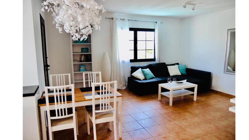 a living room with a couch and a table at Villa Sunshine in Corralejo