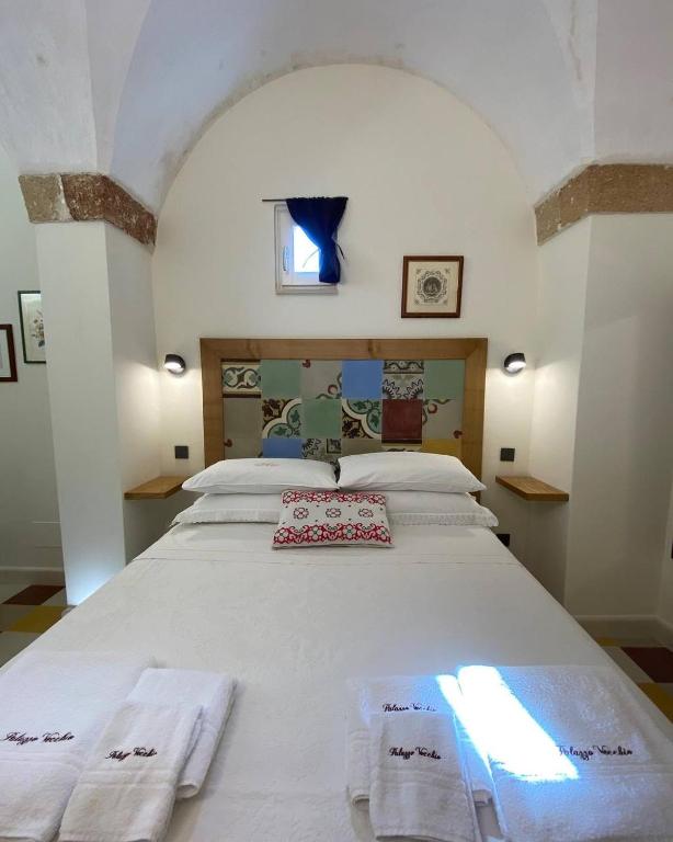 Postel nebo postele na pokoji v ubytování Palazzo Vecchio Cocumola