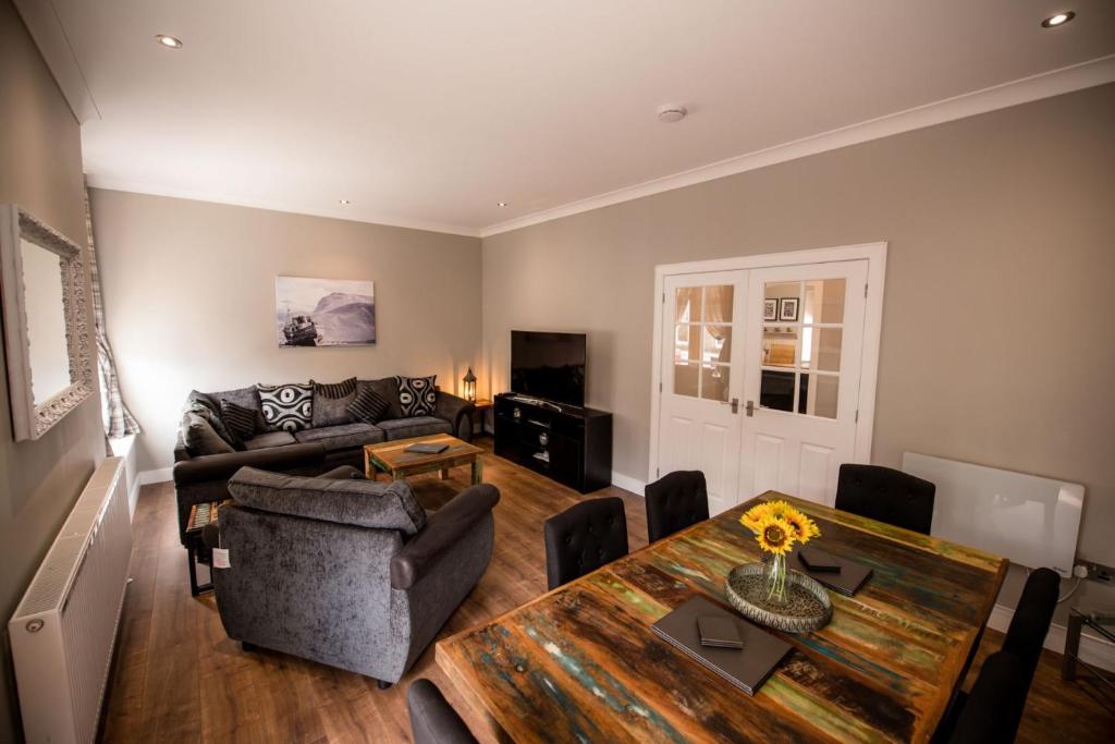 a living room with a table and a couch at The Townhouse in Fort William
