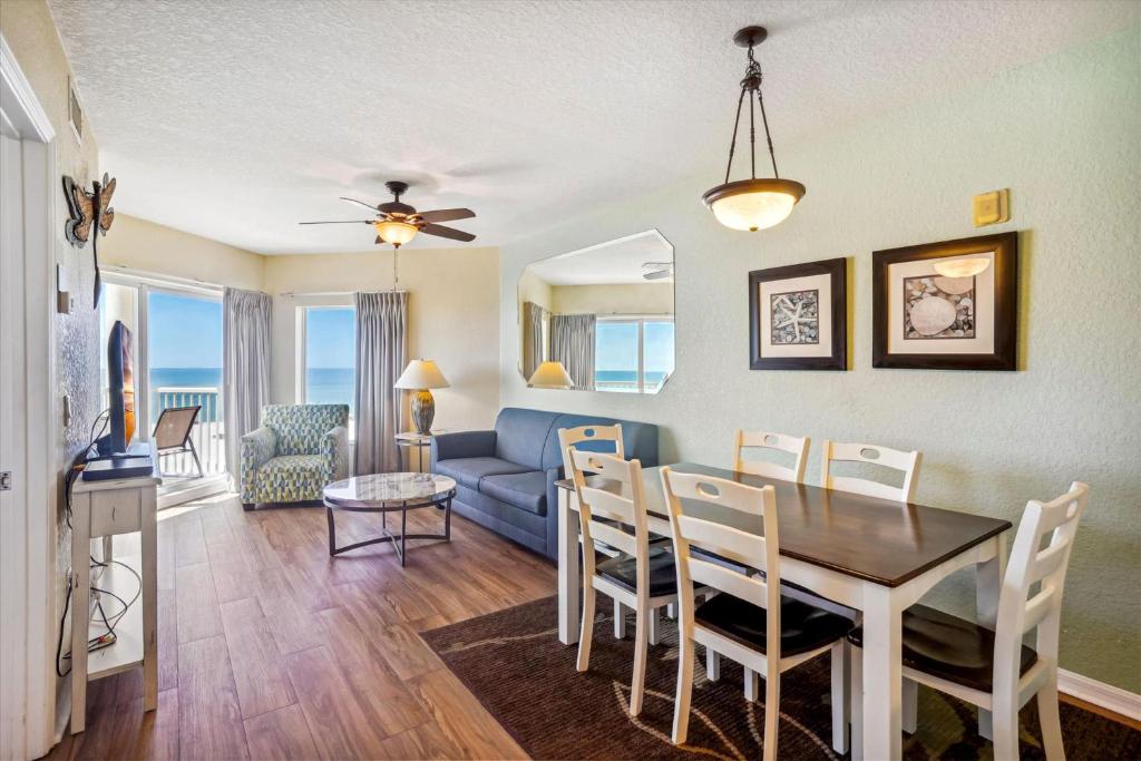 a dining room and living room with a table and a couch at Sunset Vistas 501W in St Pete Beach