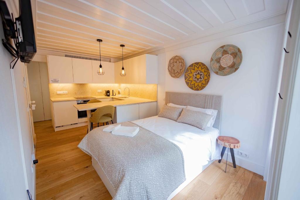 a small bedroom with a bed and a kitchen at New Lisbon Center Apartment in Lisbon