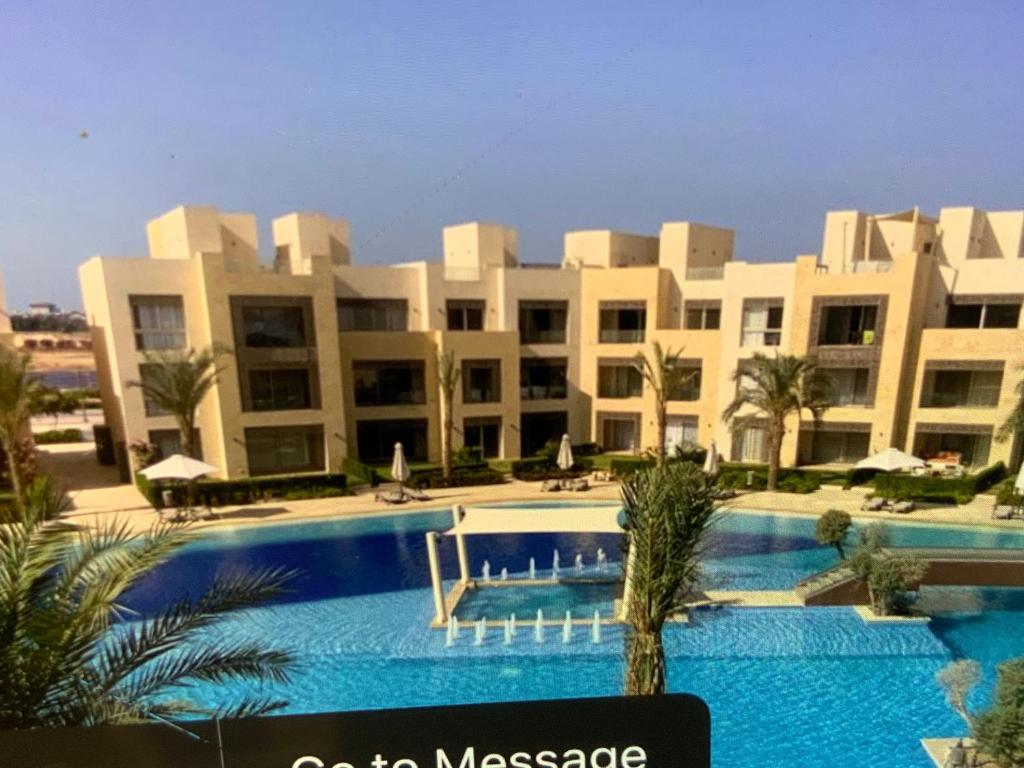 a large apartment building with a large swimming pool at Elgouna Hurghada egypt mangroovy in Hurghada