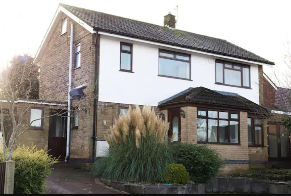 a white house with black windows at Mickleover House-Large Detatched Family House in Derby